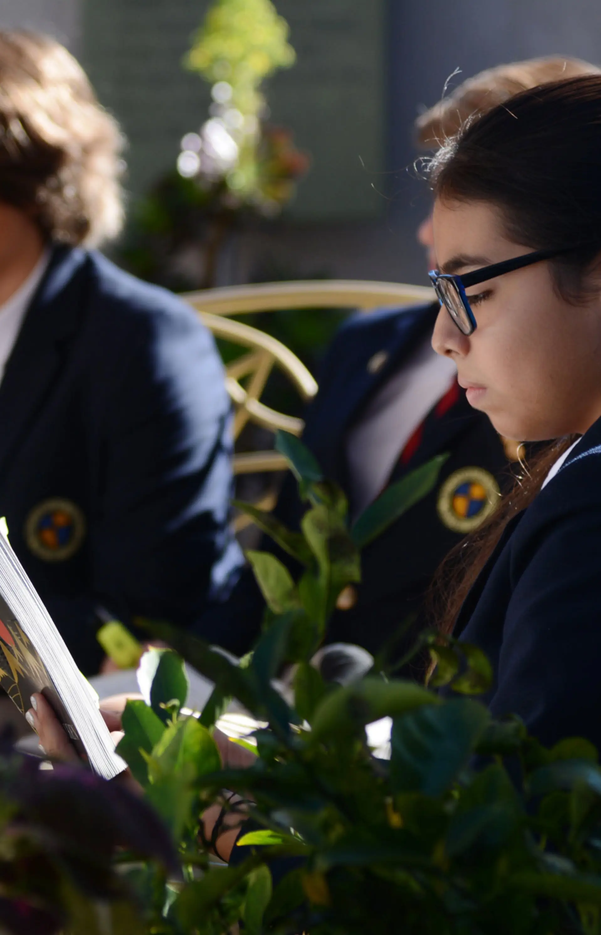 Middle School students in dress uniform read The Hobbit during a literature class at The Cambridge School.