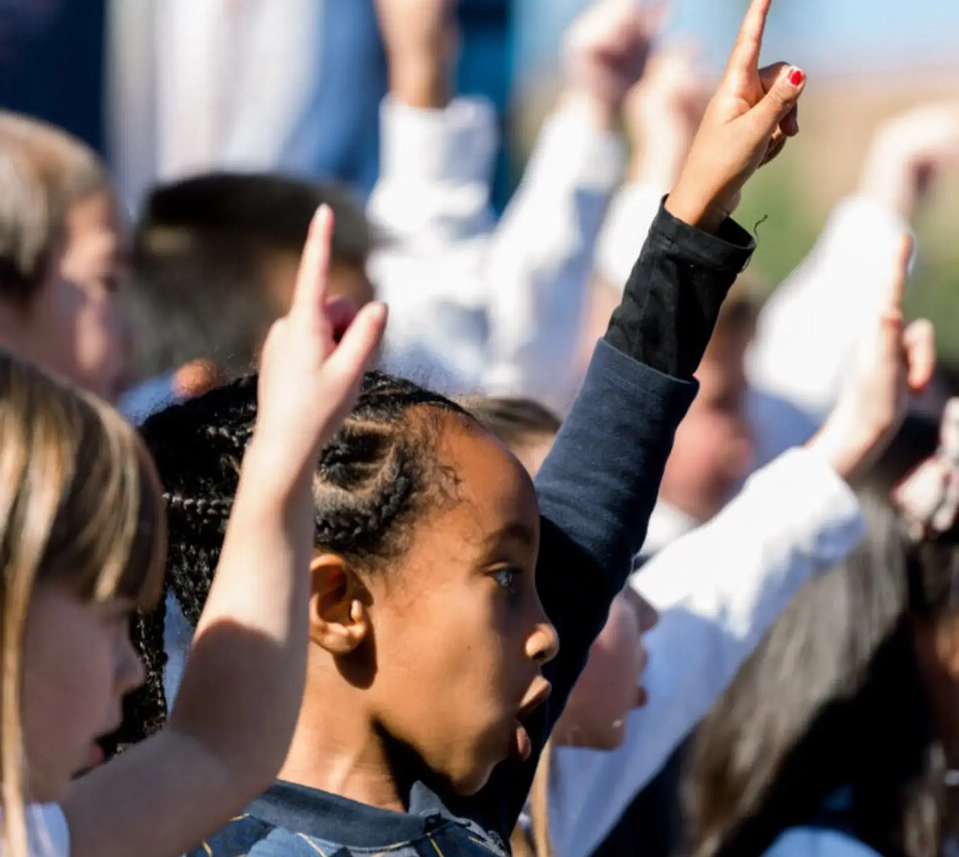 Students pointing to sky