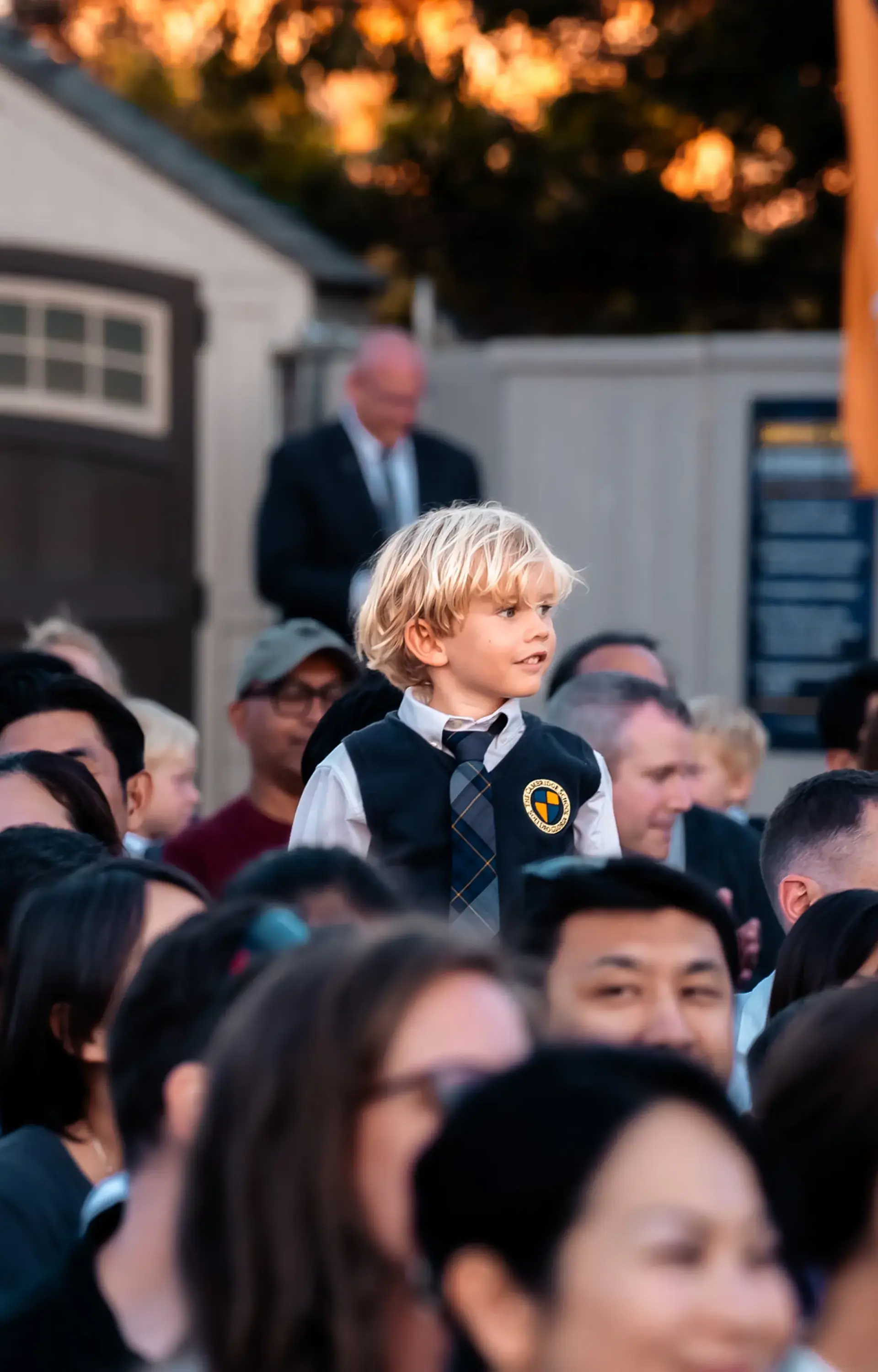 Student standing up among crowd at opening convocation