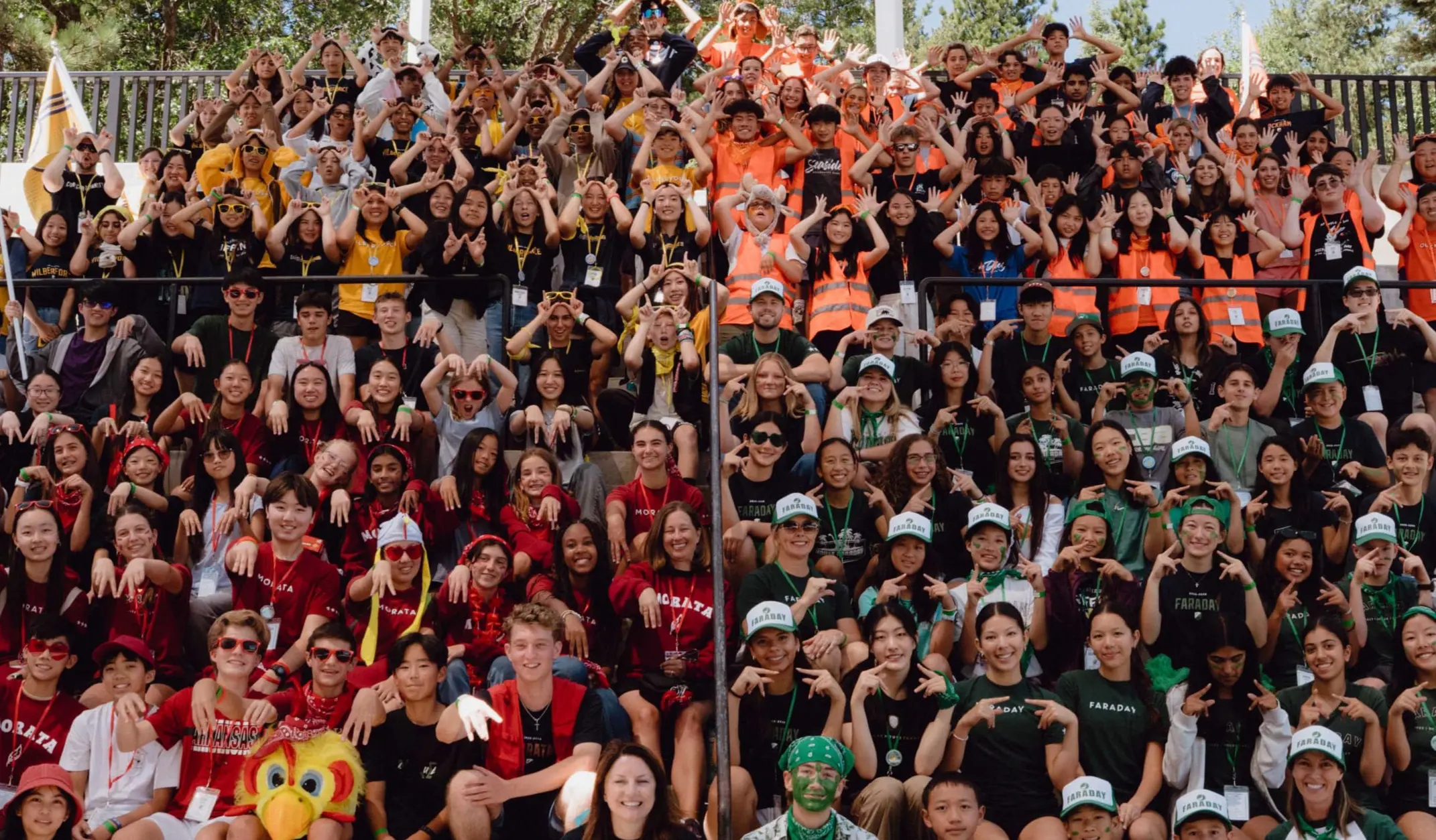 Upper school students split into their houses and gather for a group picture at house retreat.