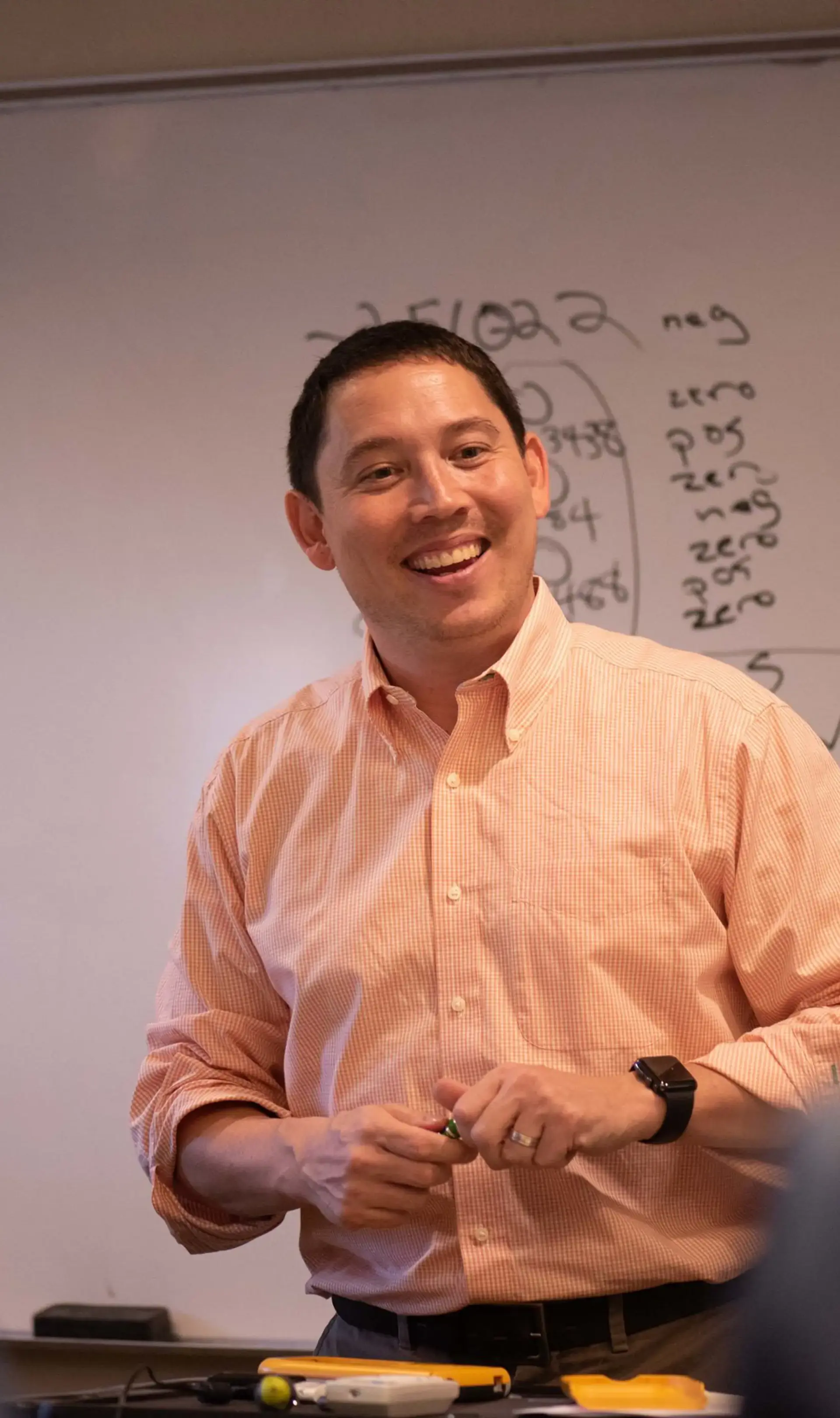 Math teacher standing in front of whiteboard