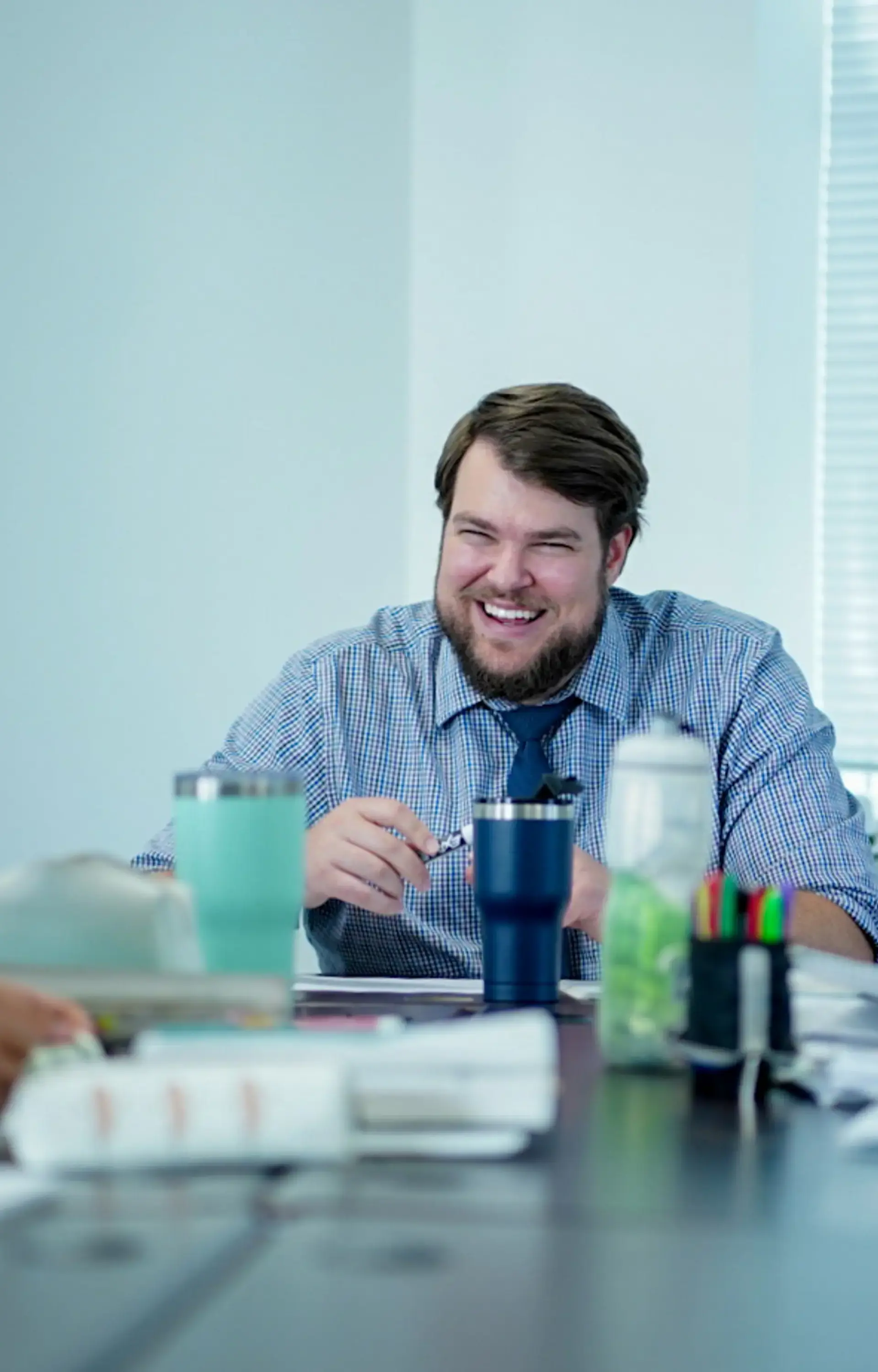 Smiling teacher sitting at desk