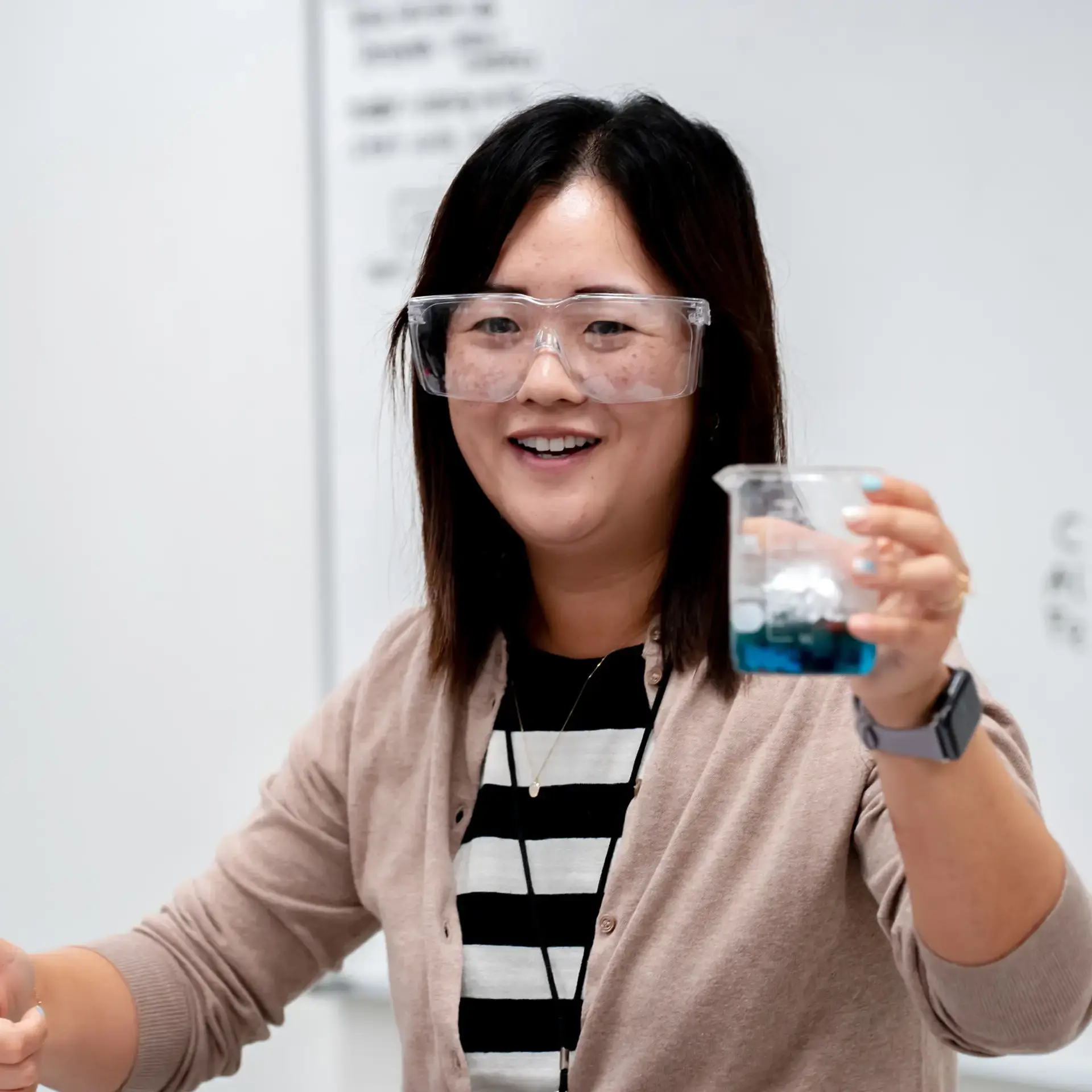 Teacher holding up beaker