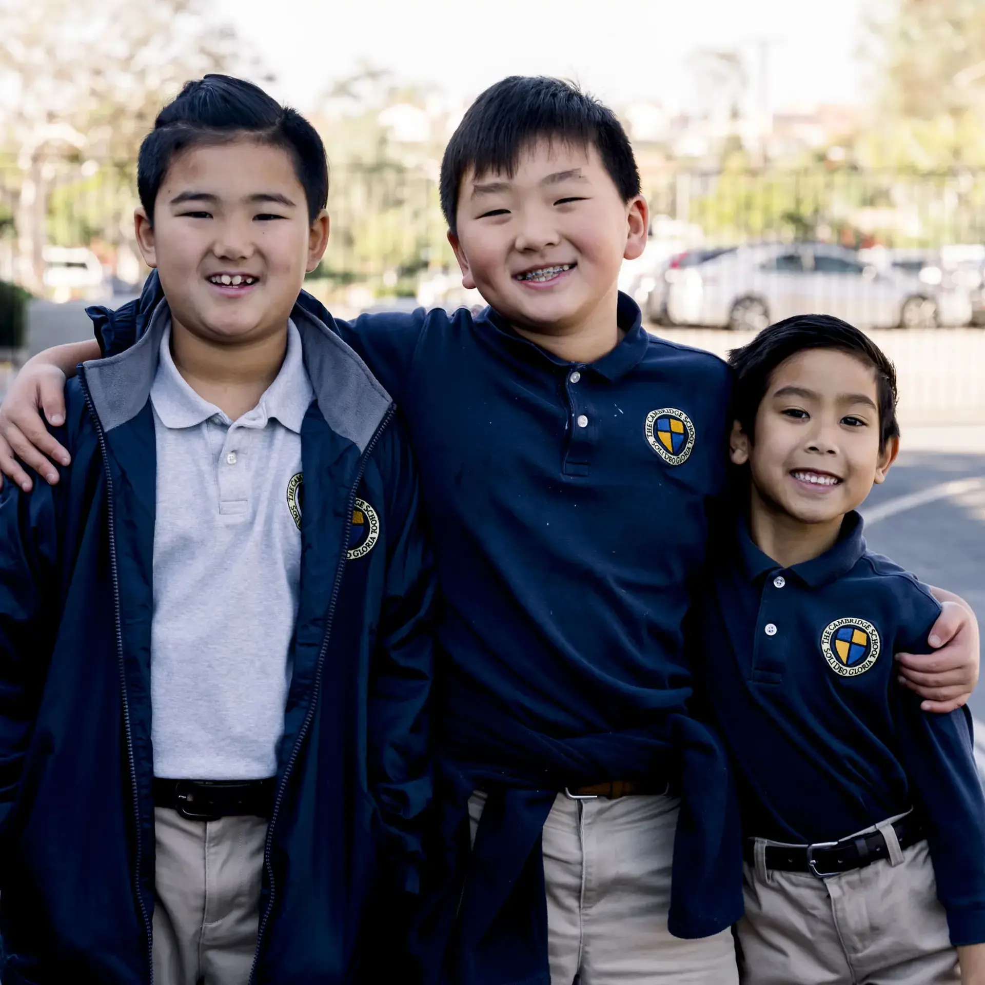 Three students smiling together