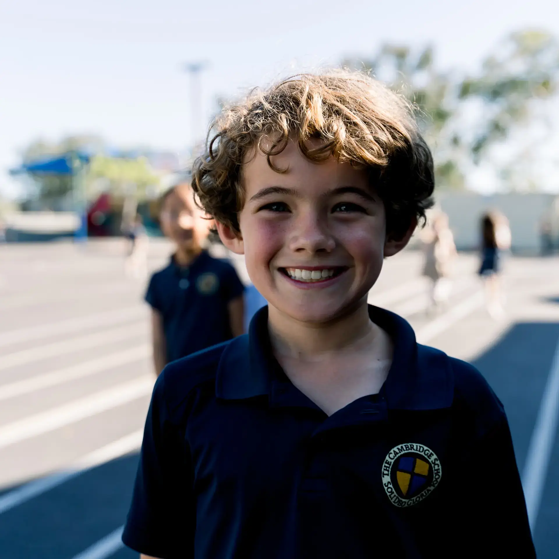 Student smiling on sunny playground