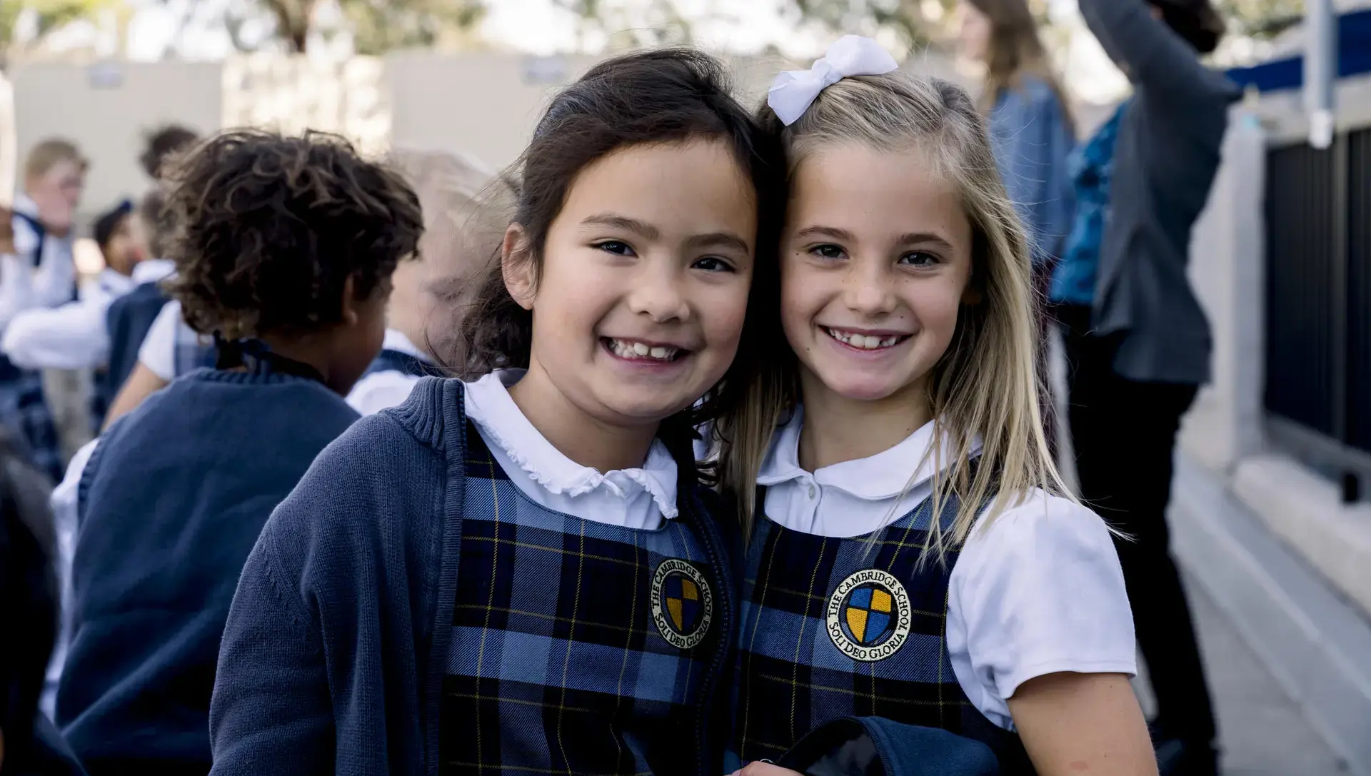 Two students smiling in sunshine