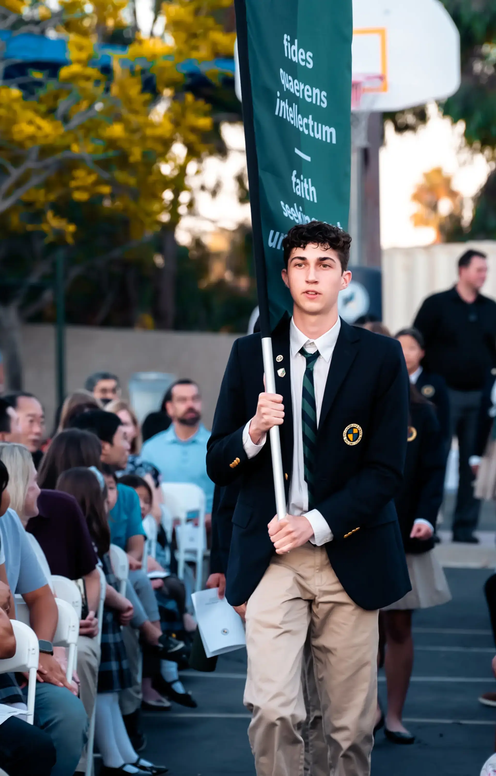 Student carrying flag at convocation