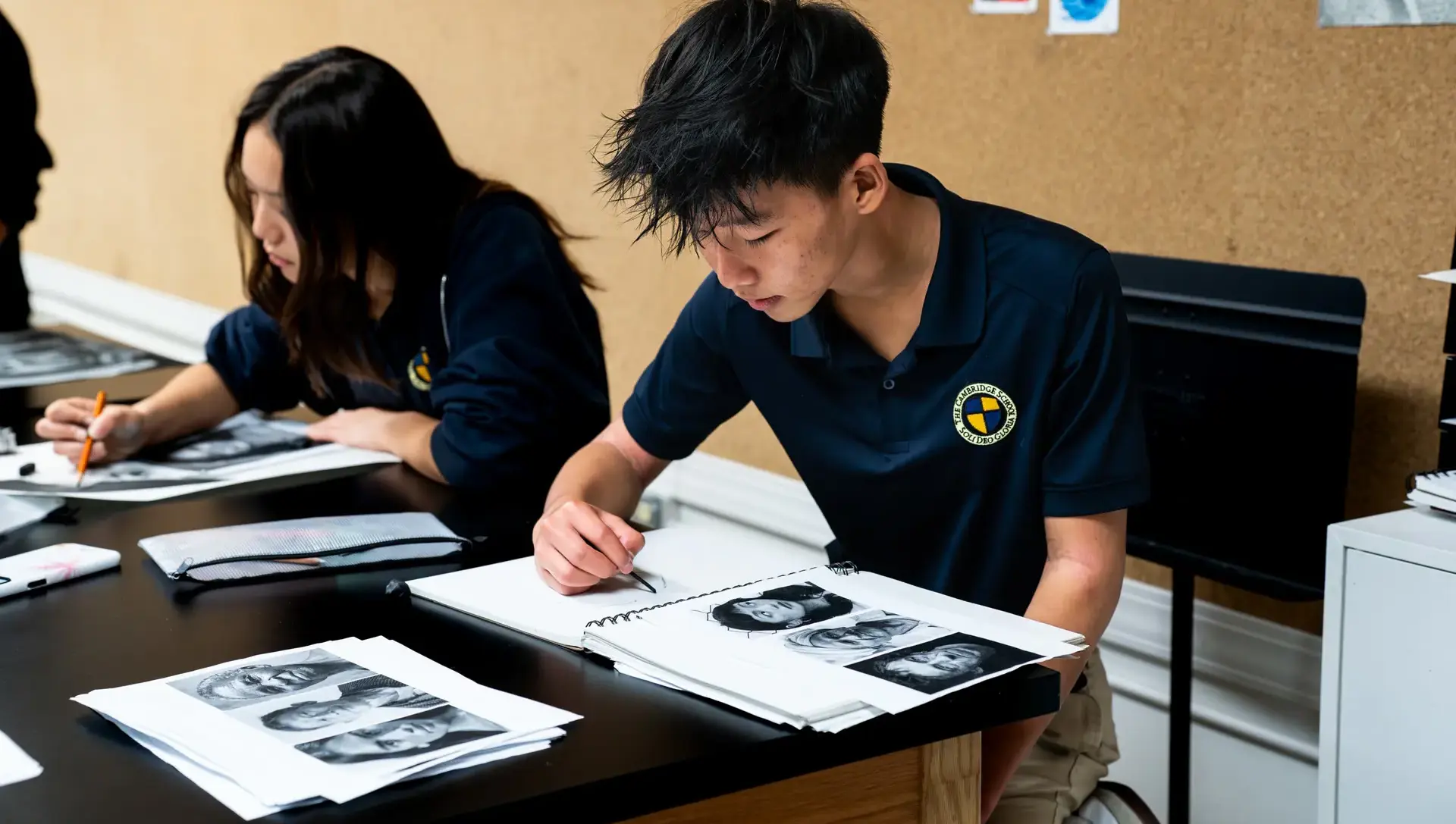 Student examining work in art class