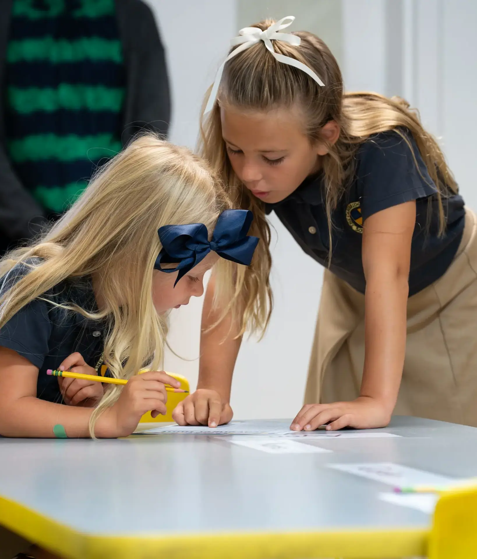 Student glances down at another student's work