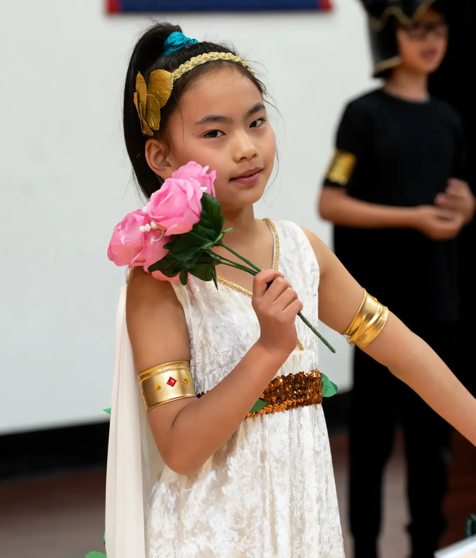 Student in costume holding flower