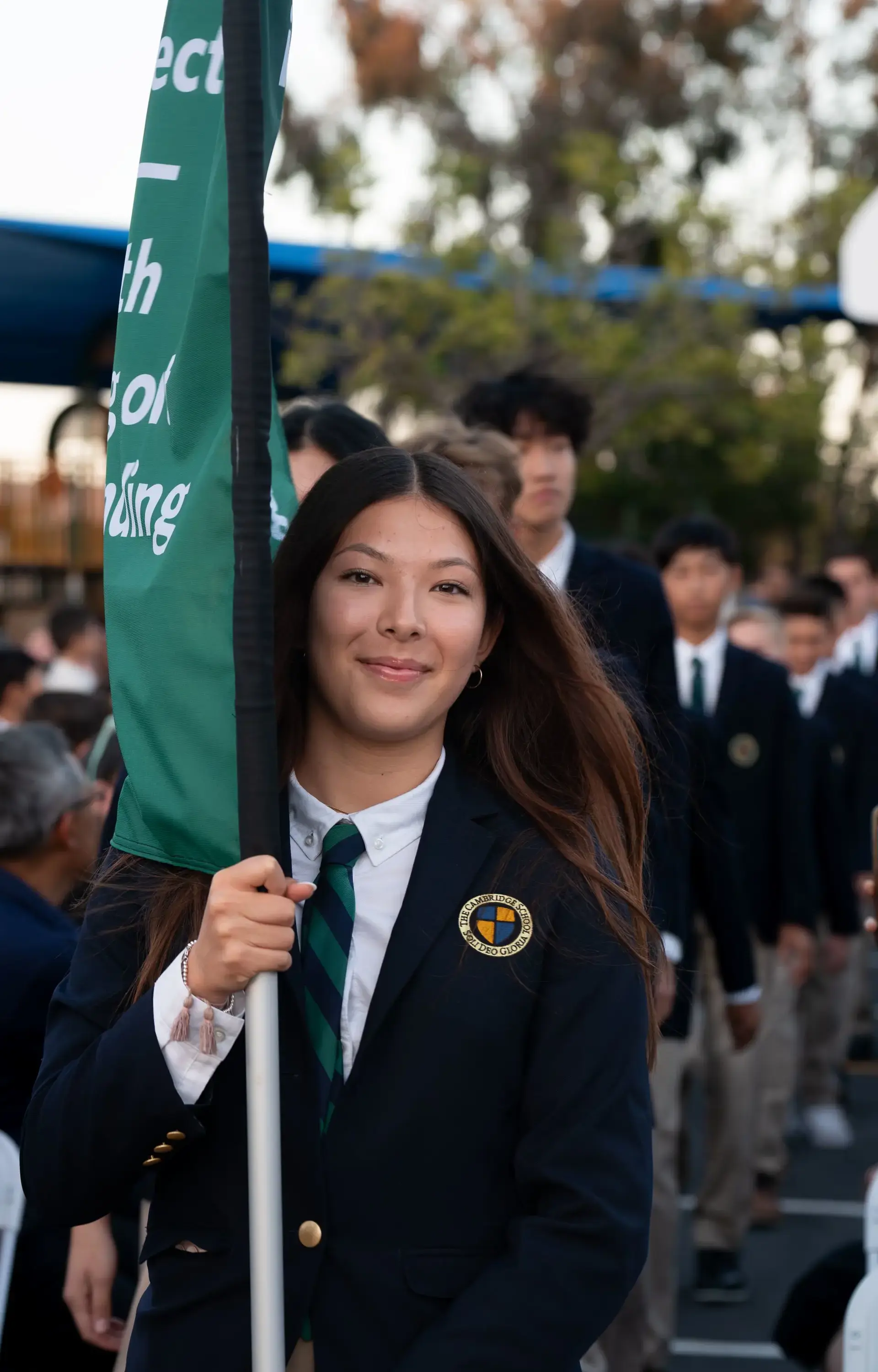 Student carrying flag at convocation