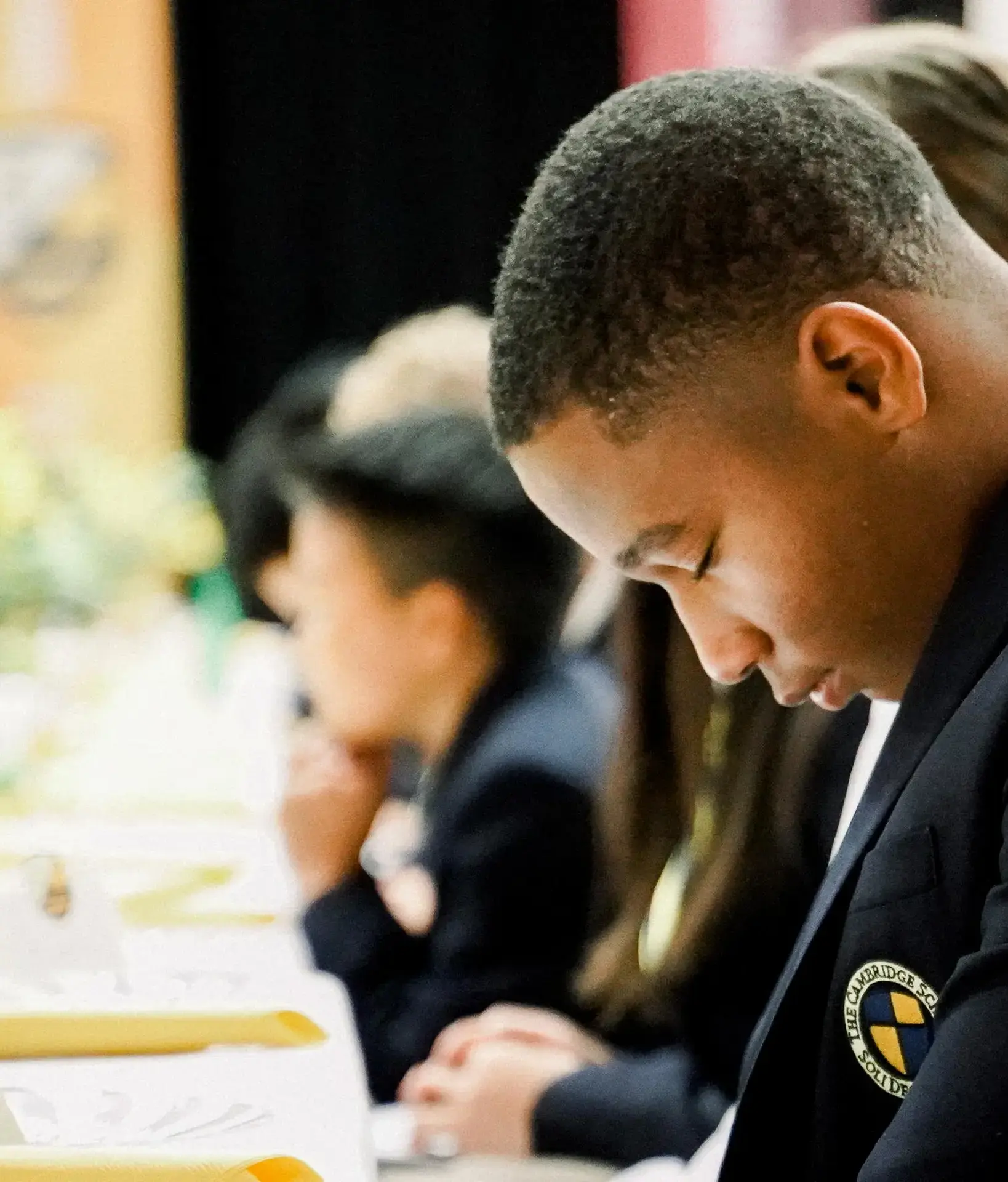 Student with head bowed in prayer