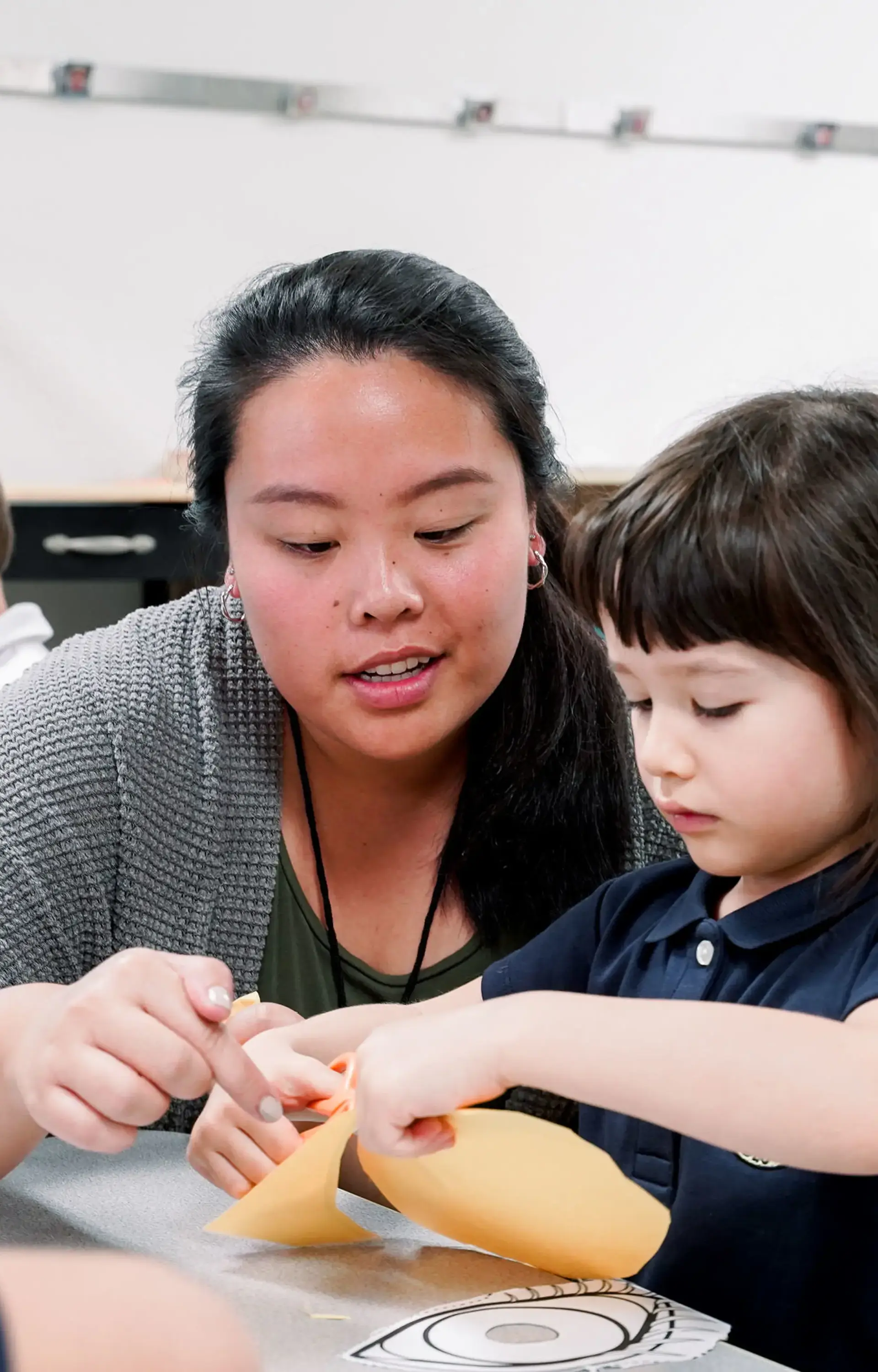 Teacher helping student in class