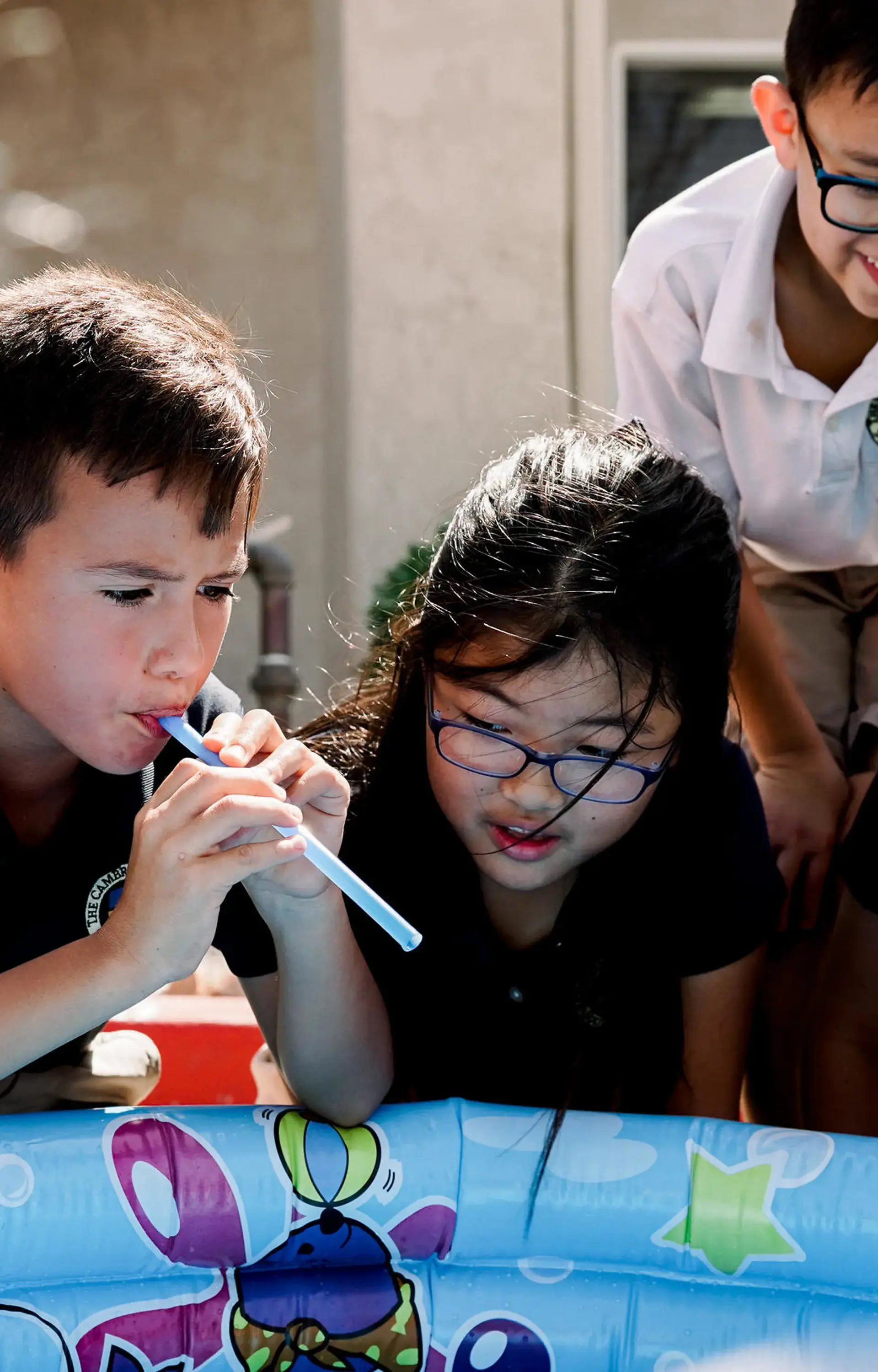 Students playing by inflatable pool