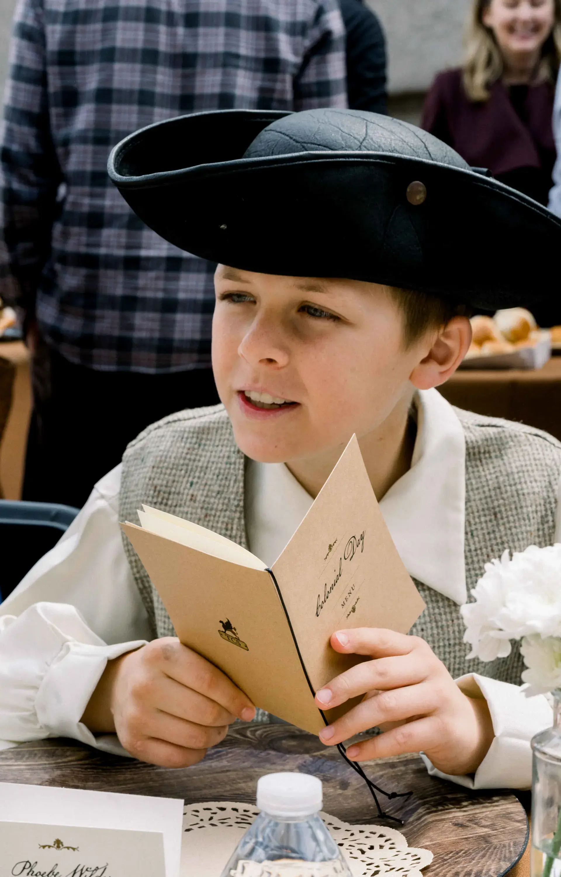 Student in costume reading from menu