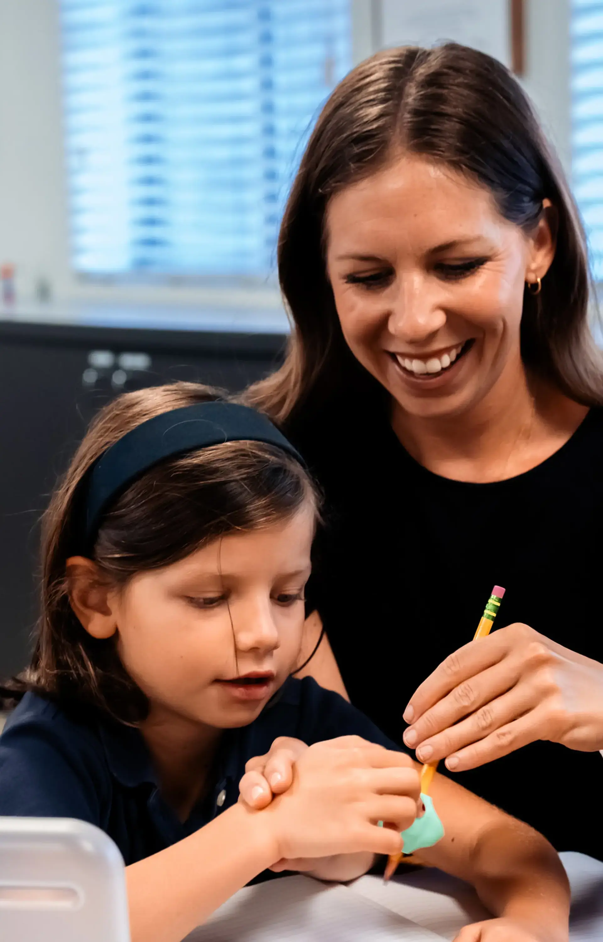 Student and teacher collaborating in class
