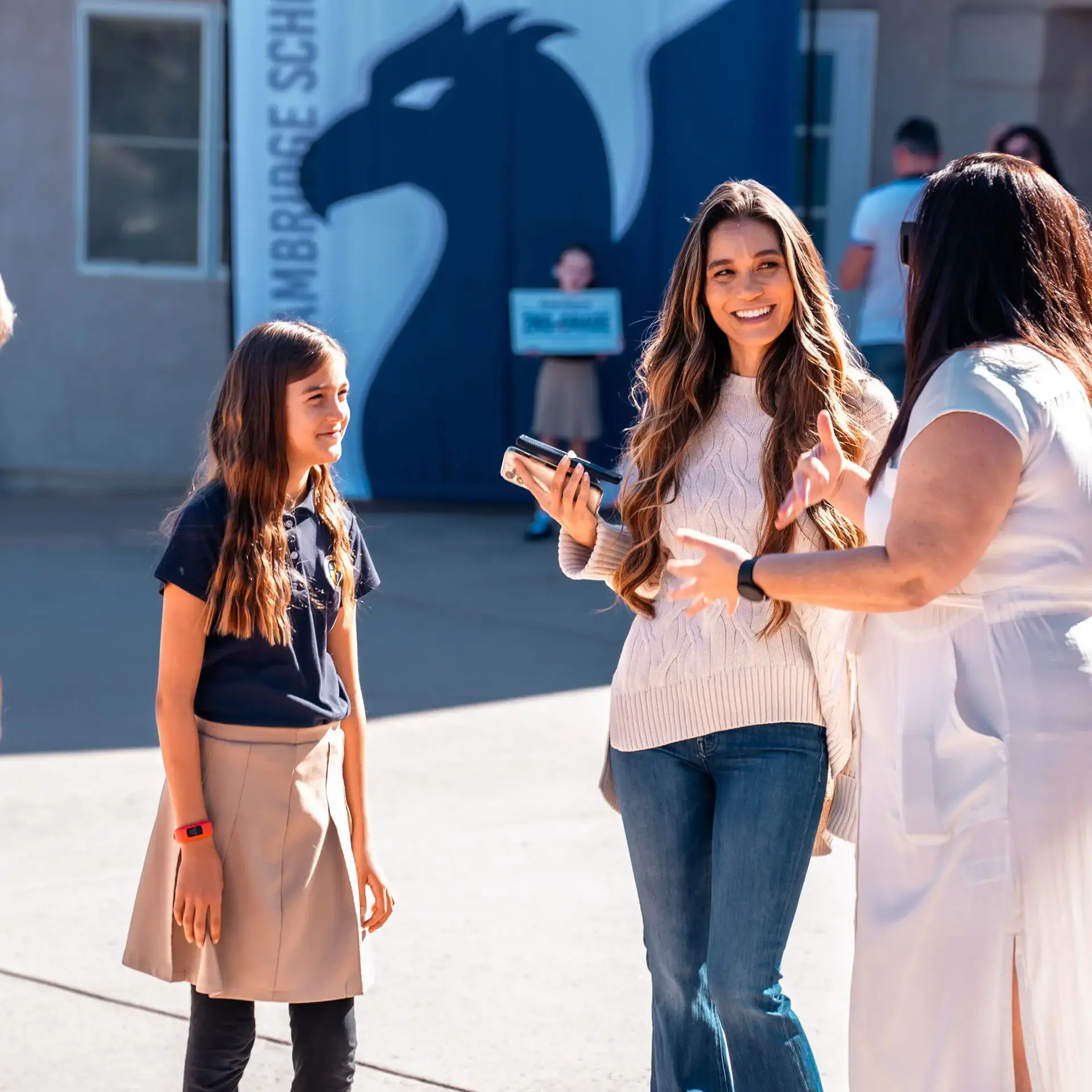 Director of Enrollment Management Leslie Yoder welcomes a family back to The Cambridge School on Meet the Teacher Day.