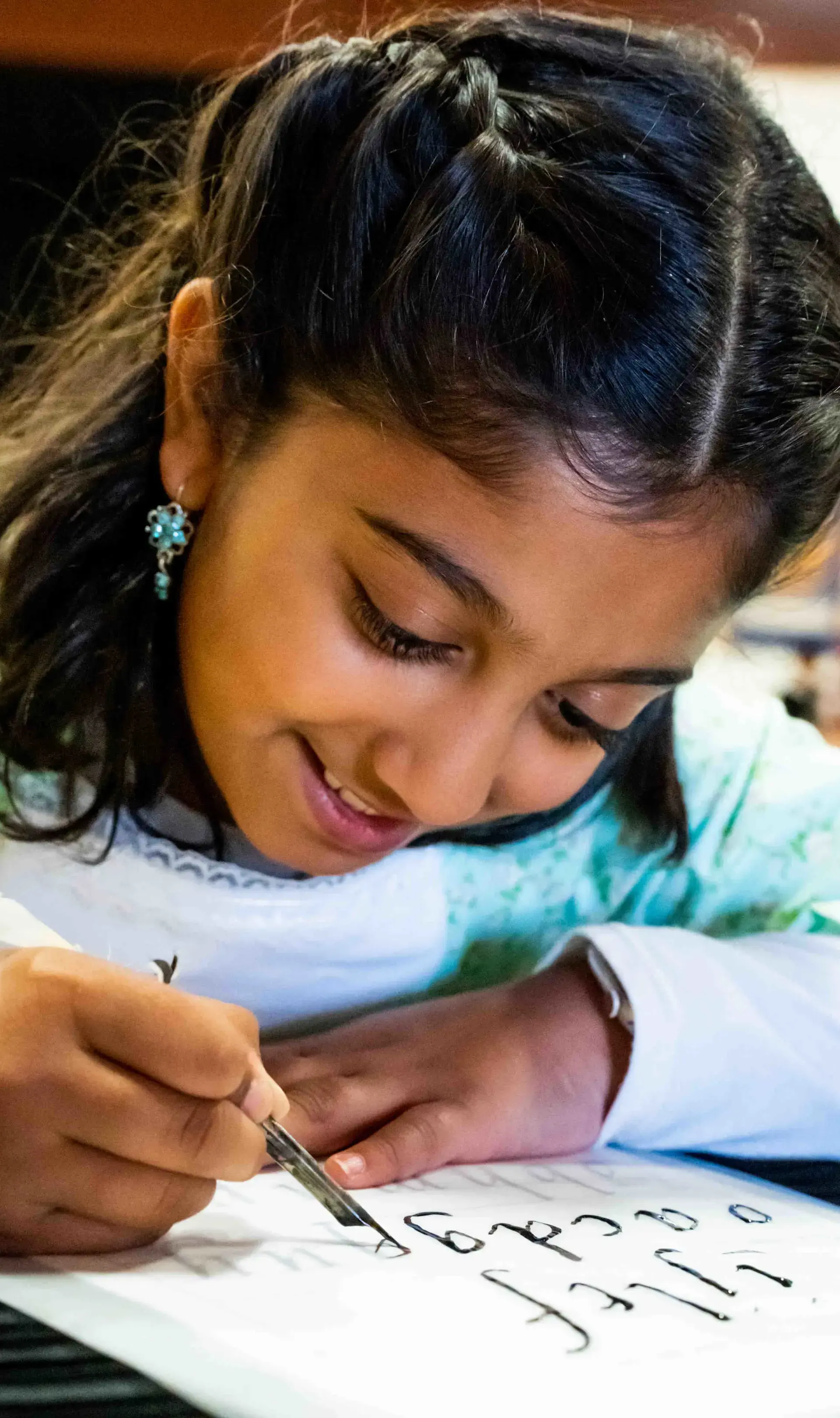 Smiling student writing