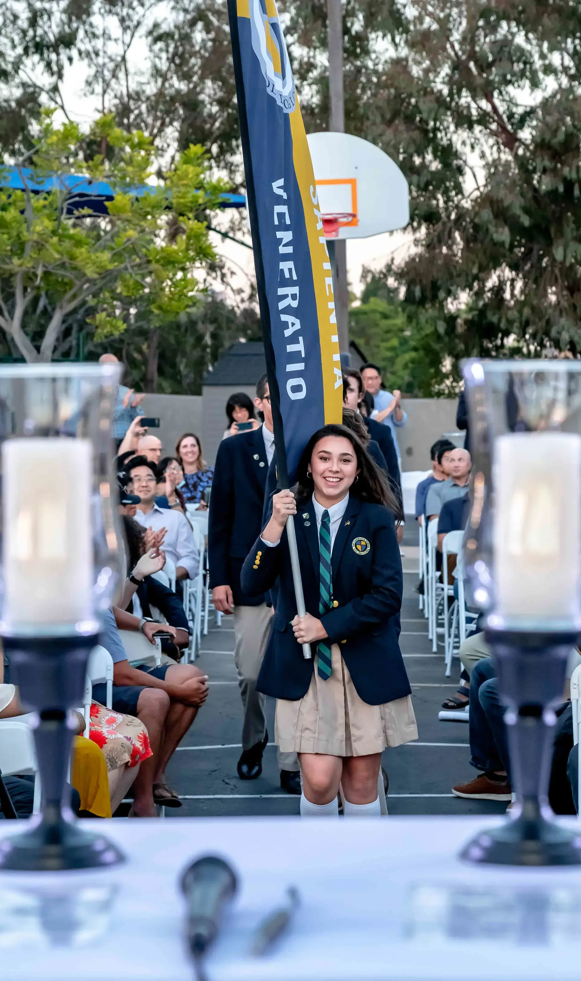 Student carrying flag at convocation
