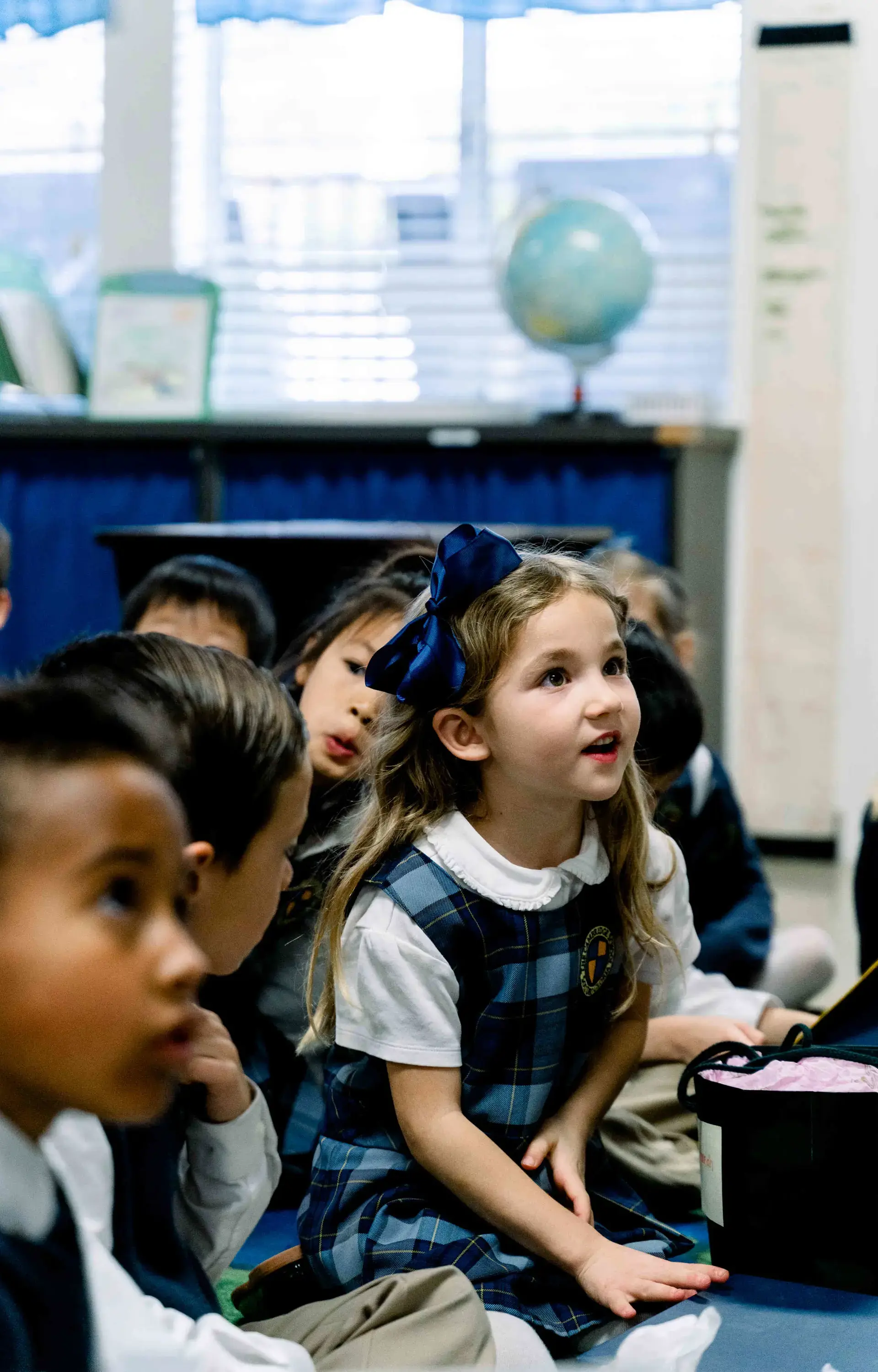 Students sitting on floor and listening in class