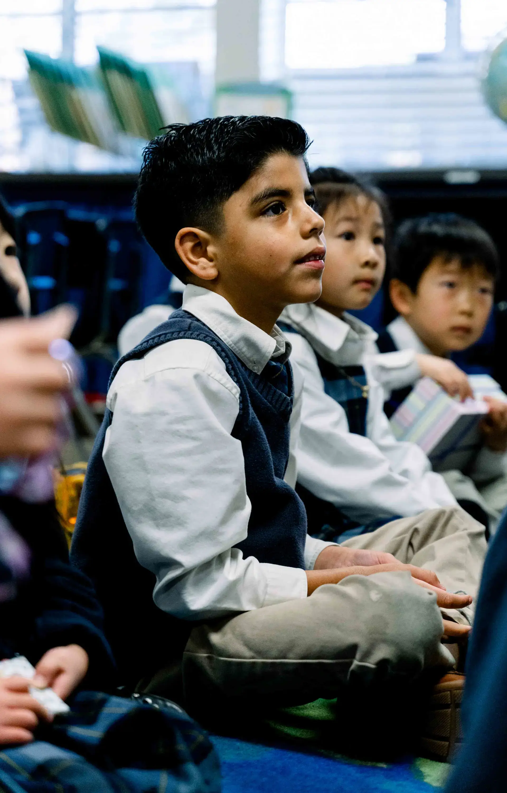 Students sitting cross-legged on floor