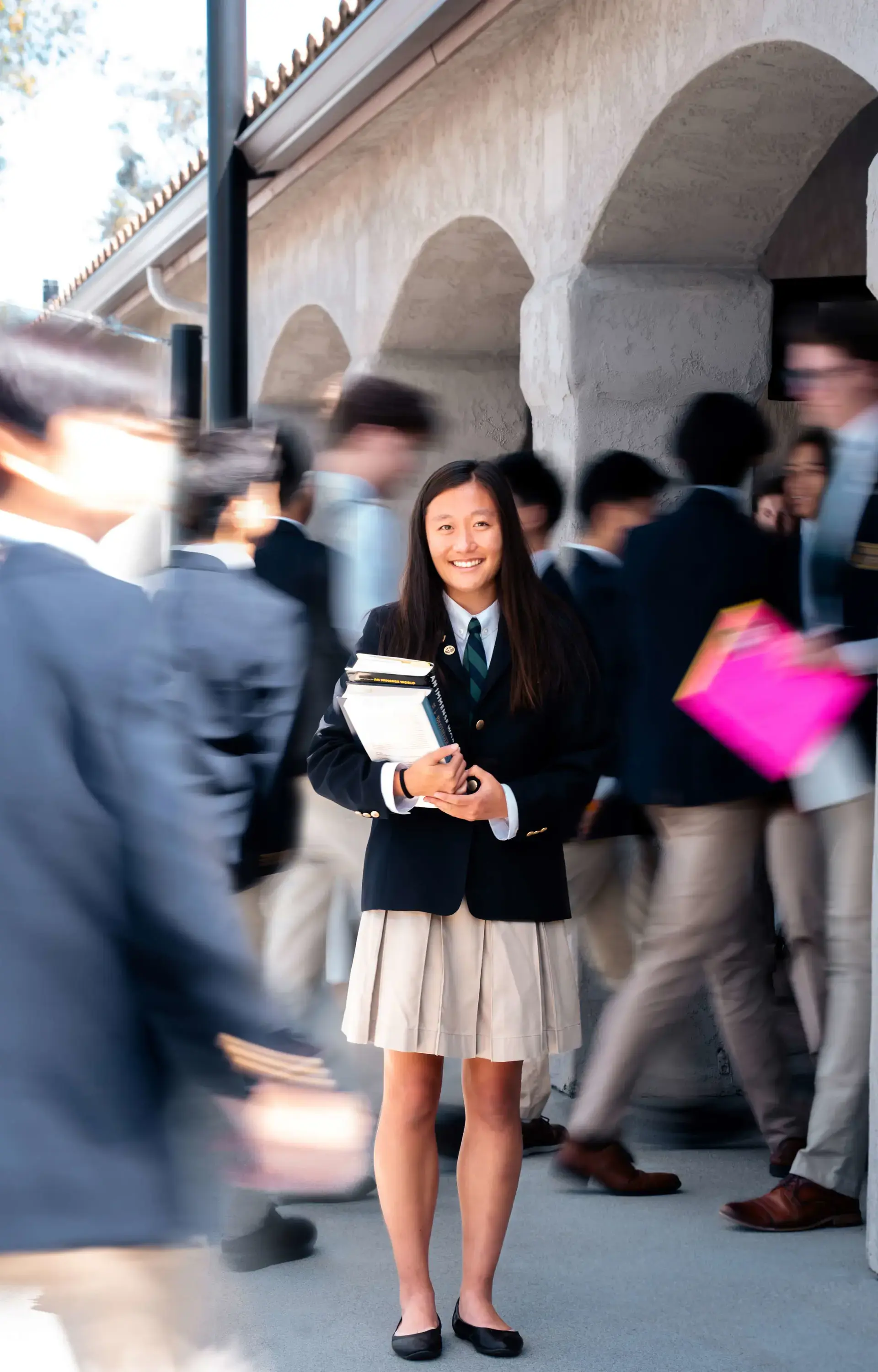 A student at The Cambridge School, a private Christian school in San Diego, stands calmly amidst the bustle of passing classmates.