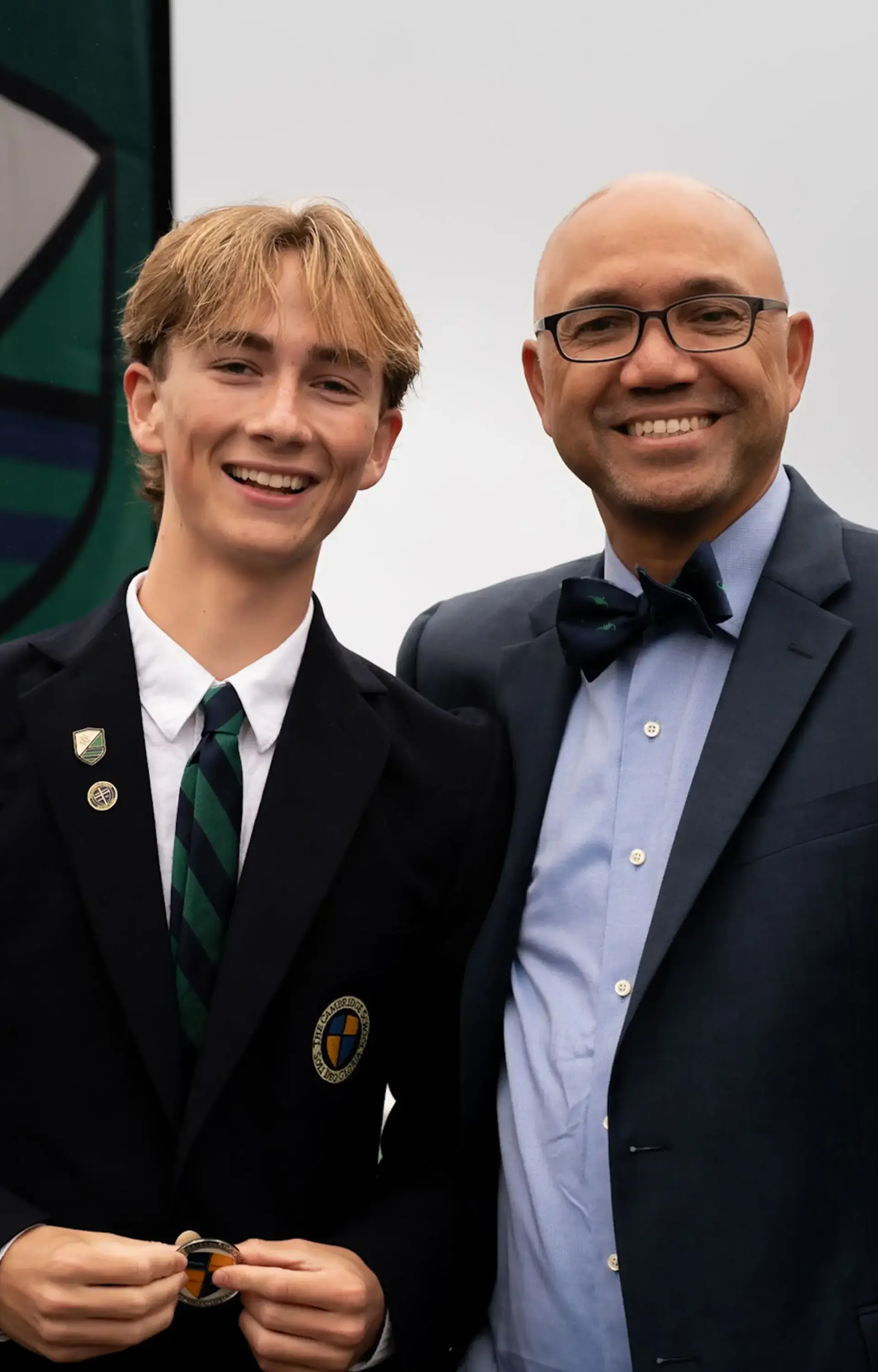 A student and faculty member at The Cambridge School, a private Christian school in San Diego, share a joyful moment during a school ceremony.