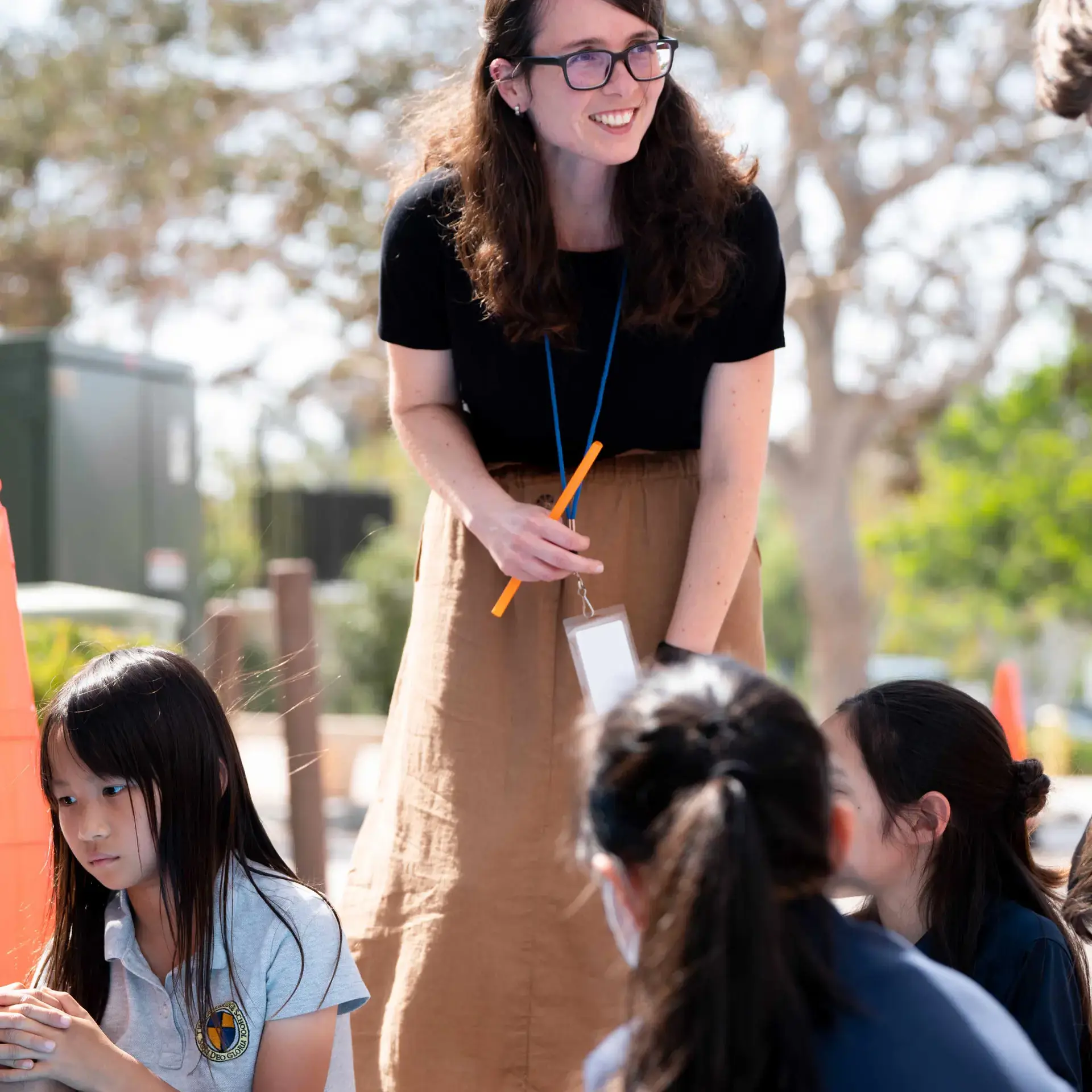Third grade teacher at The Cambridge School leads an outdoor science lesson on forces.