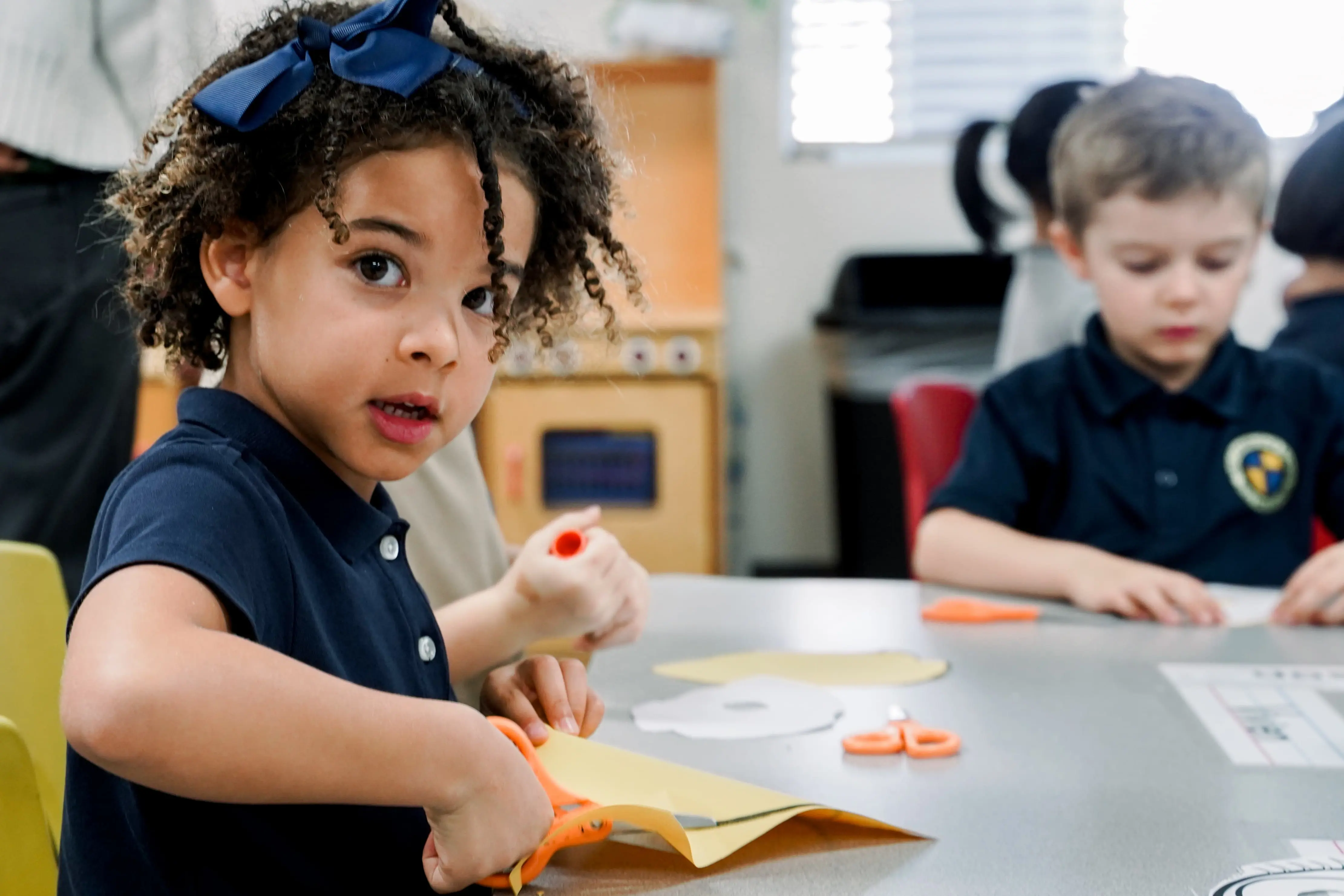 Junior Kindergartener at The Cambridge School in San Diego participates joyfully in arts and crafts