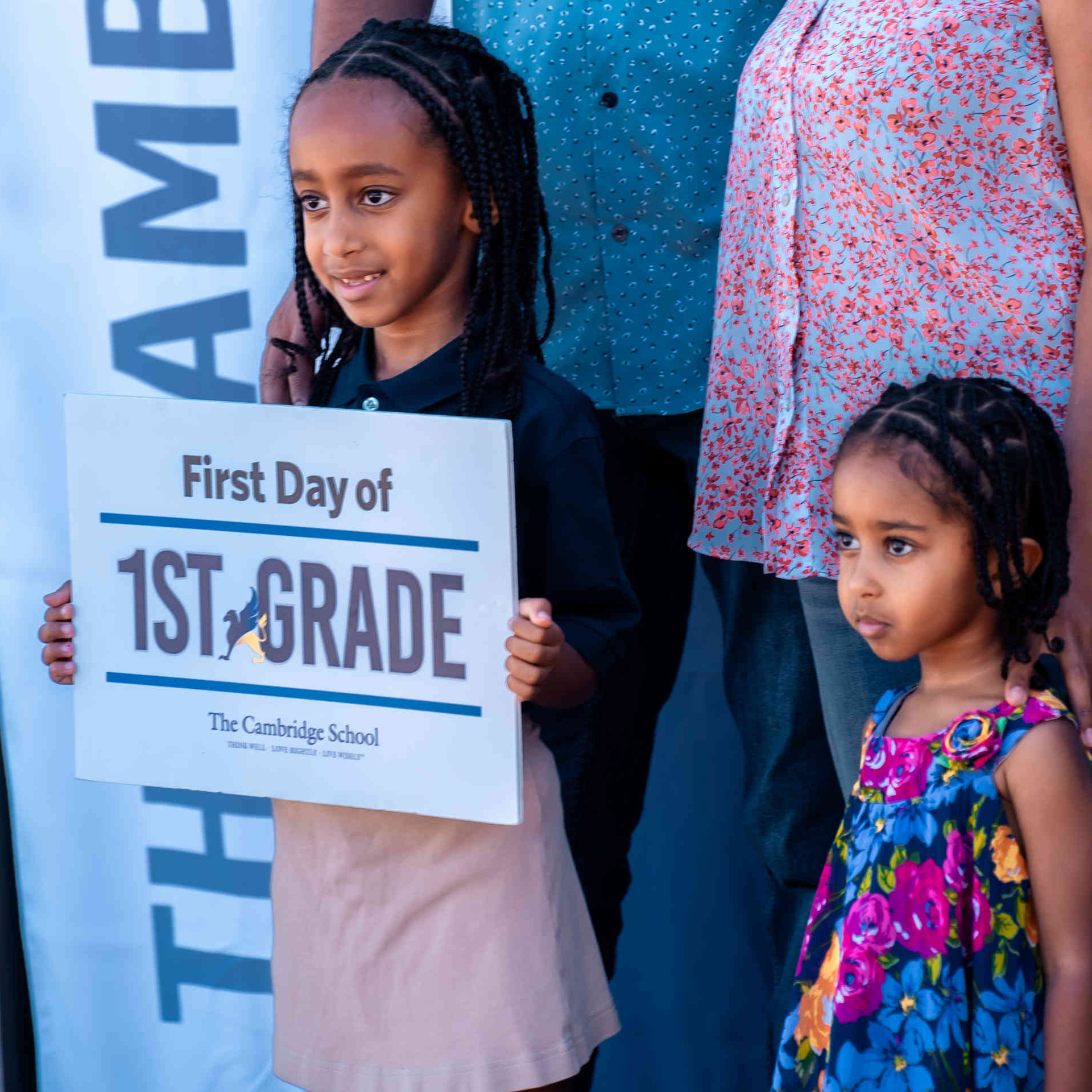 A Cambridge School family poses for a first day of school photo, celebrating their daughter’s first day of 1st grade at this private Christian school in San Diego.