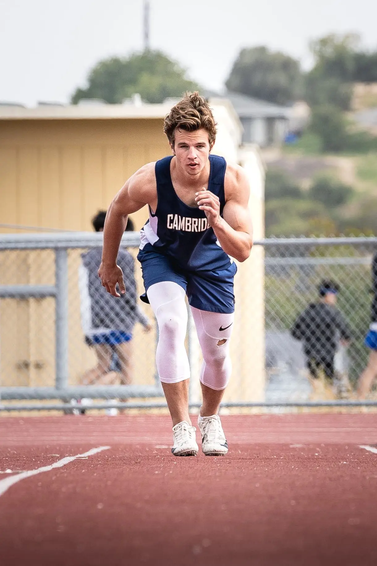 A Cambridge student athlete prepares to run at a track and field meet.