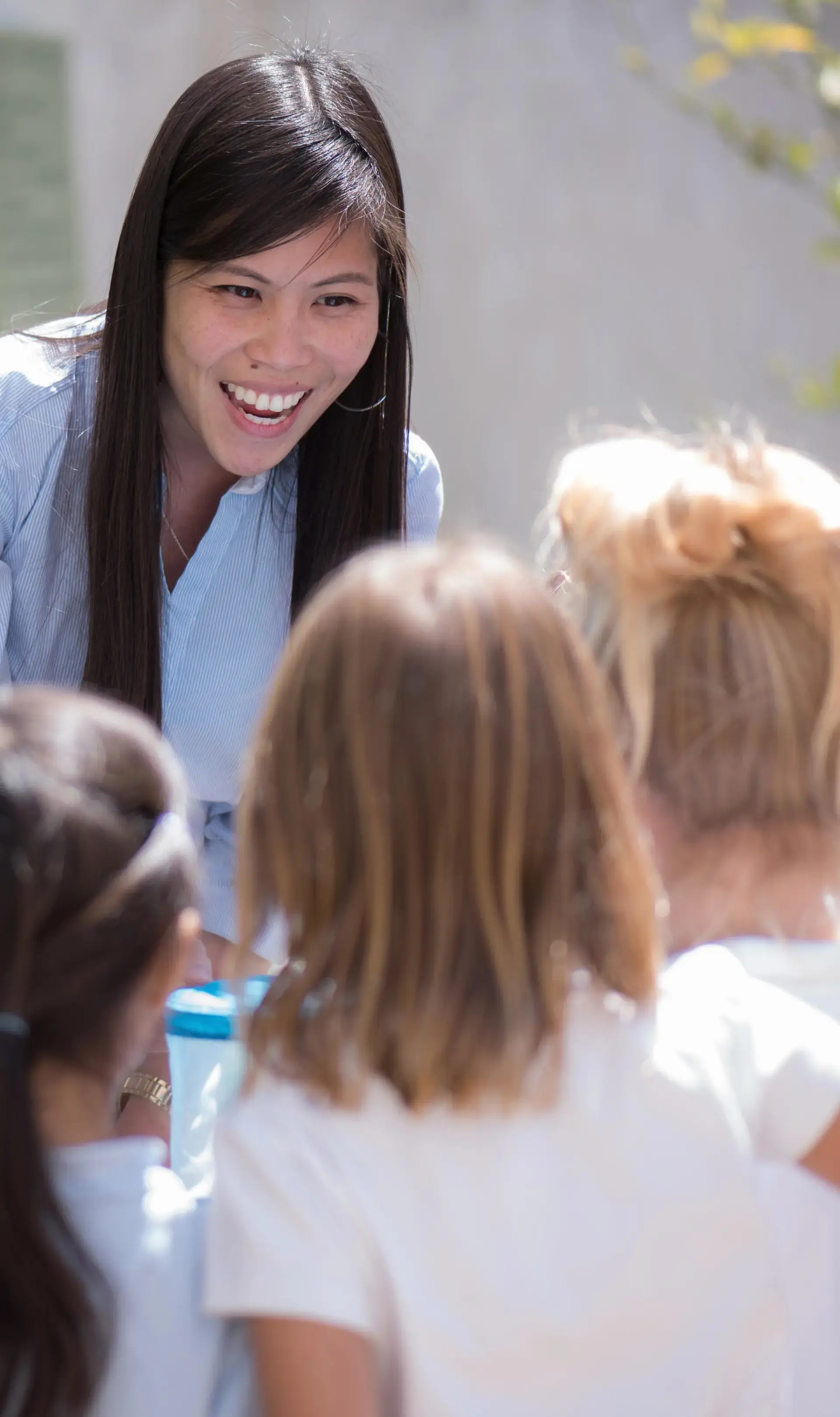 Teacher smiling down at kindergartners