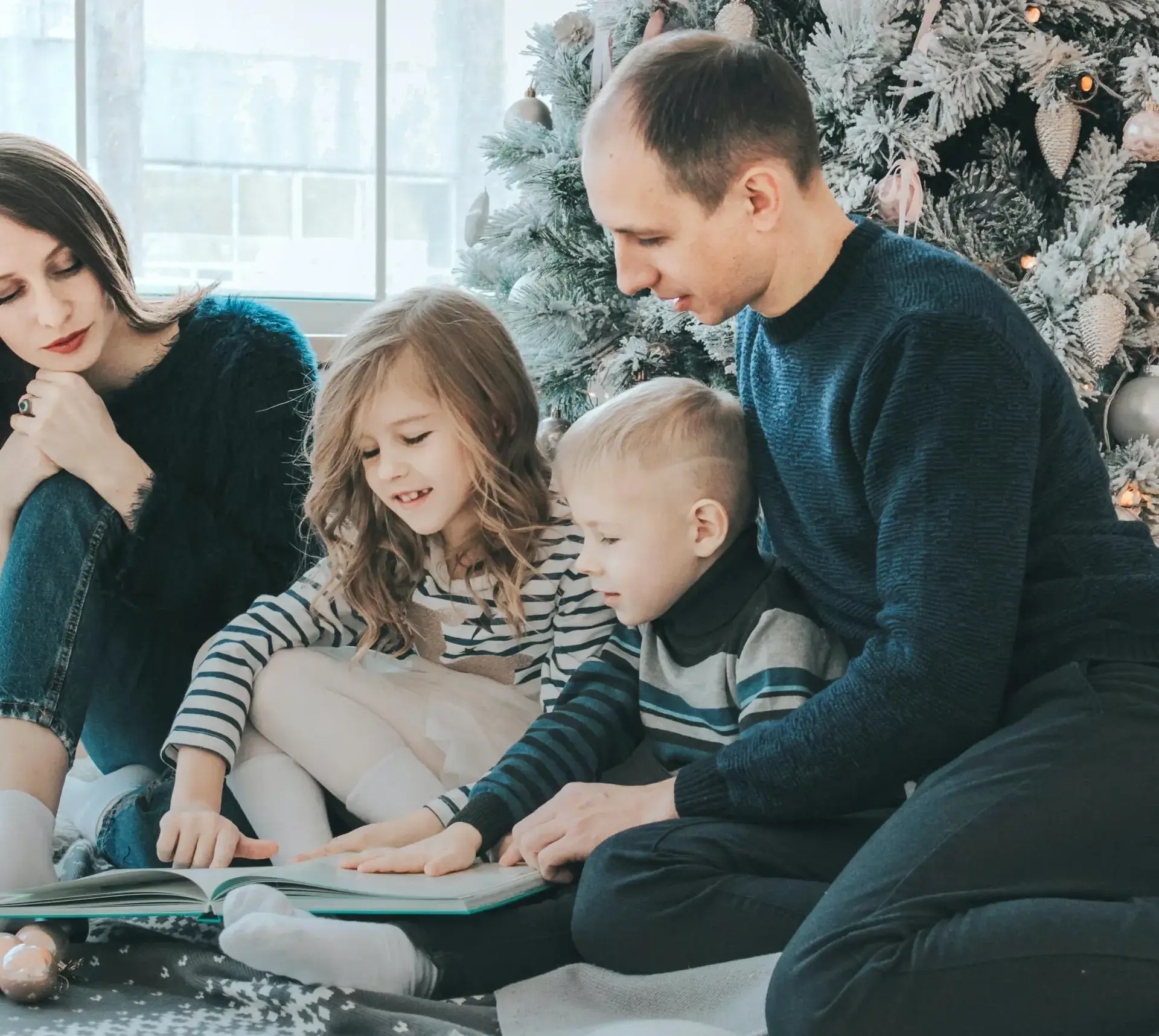 Family reading together on carpet